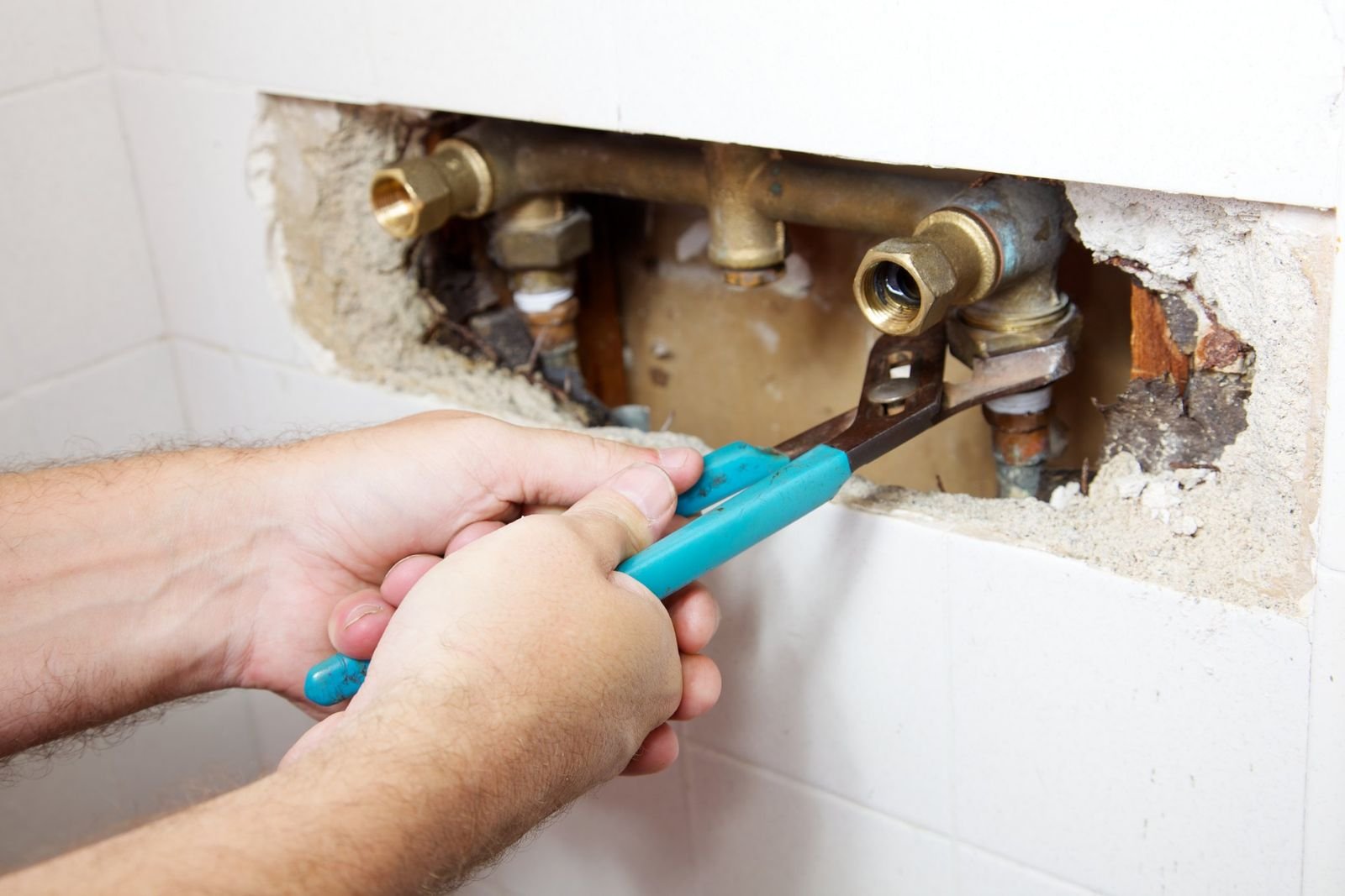 Electrician inspecting a consumer unit by head torch during a power cut